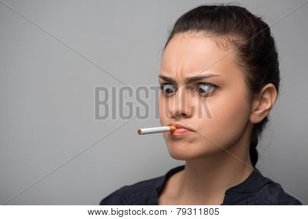 Addiction. Closeup of young woman determined girl holding cigare