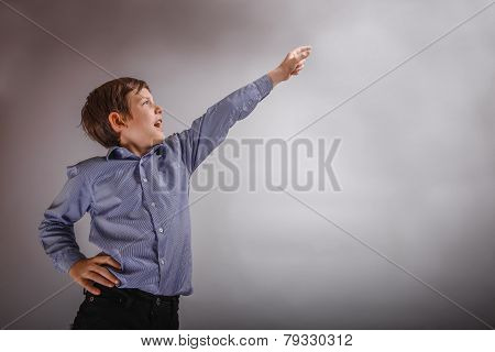 adolescent boy brown experiences happiness showing thumb up on a