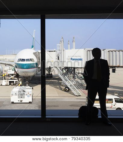 Silhouette Of A Businessman Waiting For Boarding In An Airport