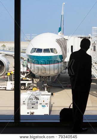 Silhouette Of A Businessman Waiting For Boarding In An Airport