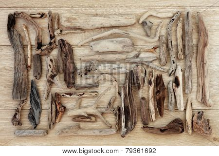 Driftwood selection over old oak wood background.