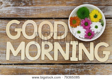 Good morning written with wooden letters and santini flowers