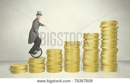 Business man riding monocycle up on coin graph concept on background