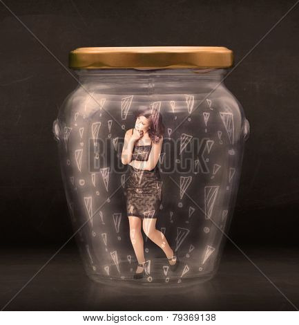 Business woman trapped in jar with exclamation marks concept on bakcground