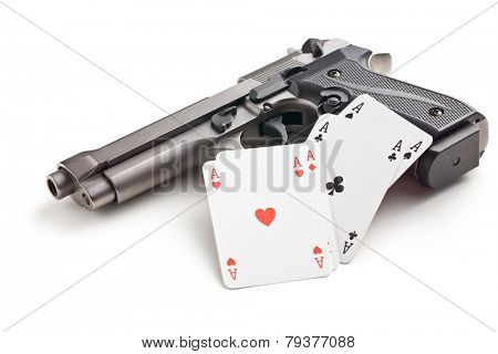 handgun and poker cards on white background