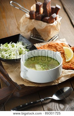 Chicken broth with egg, fried meat in batte