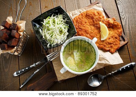 Chicken broth with egg, fried meat in batte