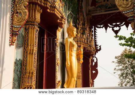 Standing Buddha Front Of Church On Thai Temple In Thailand.