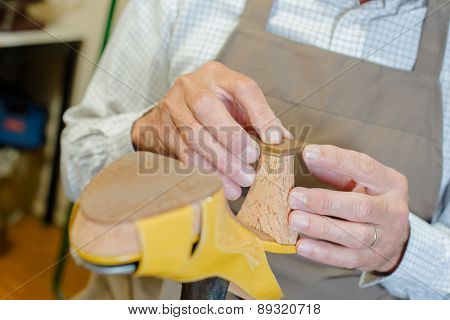 Cobbler working on a shoe heel