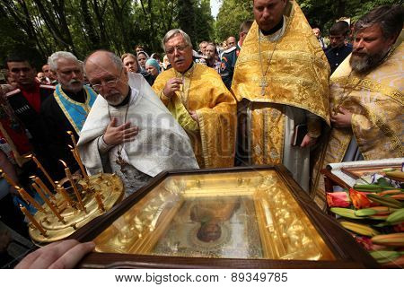 PRAGUE, CZECH REPUBLIC - MAY 28, 2012: Orthodox priests pray in front of the miracle-working icon of the Virgin Mary in front of the Dormition Church at the Olsany Cemetery in Prague, Czech Republic.