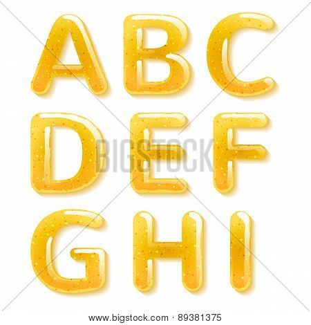 Yellow honey jelly alphabet. Glossy letters.