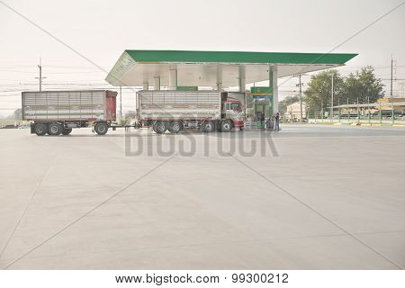 Tolled truck filling diesel fuel from local brand gas station. This tolling style truck is now illeg