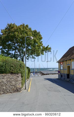 SVANEKE, DENMARK - AUGUST 14: View of a street with the typical old colored houses on 14 August 2015 in Svaneke on Bornholm Island, Denmark.