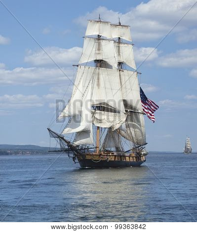 Tall Ship With American Flag Sailing On Blue Waters