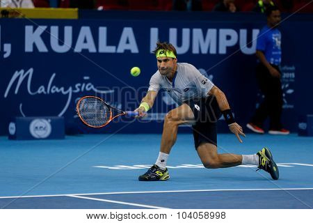 KUALA LUMPUR, MALAYSIA - OCTOBER 01, 2015: David Ferrer of Spain hits a forehand return in his match at the Malaysian Open 2015 Tennis tournament held at the Putra Stadium, Malaysia.