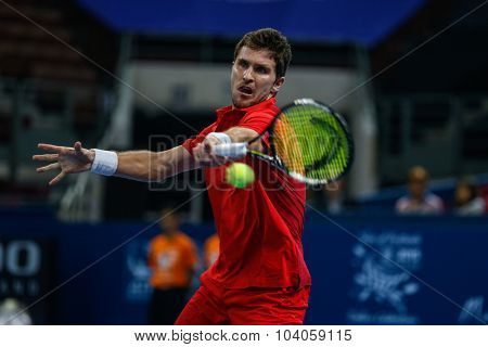 KUALA LUMPUR, MALAYSIA - OCTOBER 01, 2015: Mischa Zverev of Germany attempts a forehand return during his match at the Malaysian Open 2015 Tennis tournament held at the Putra Stadium, Malaysia.