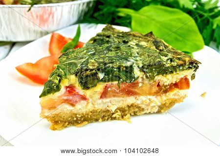 Pie celtic with spinach in  white plate on table