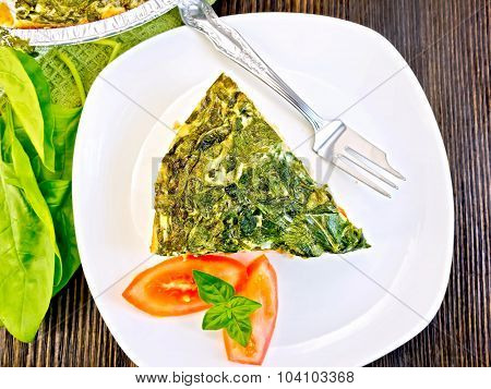 Pie celtic with spinach and tomato in plate on table top
