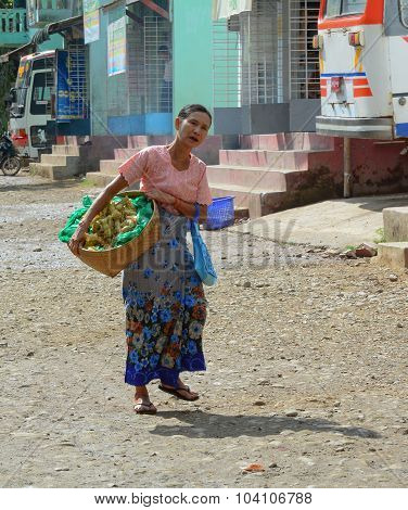 Burmese Women Carrying A Heavy Basket