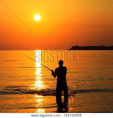 Fisherman Silhouette At Sunrise