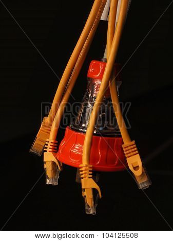 Hanging orange and clear industrial 240V power and several yellow data plugs