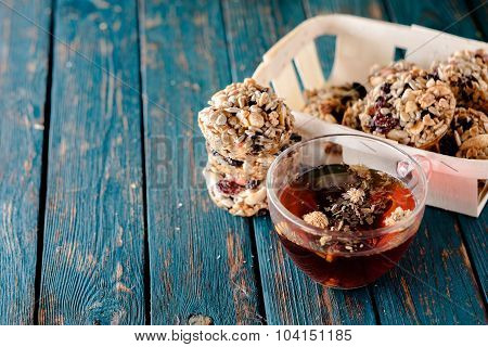 Cup Of Tea And Cookies Made Of Nuts And Raisins.
