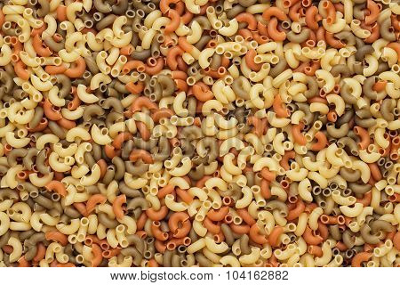 dry uncooked colored pasta texture background
