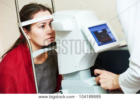 optometry. Young woman patient under eyesight examination in eye ophthalmological clinic 