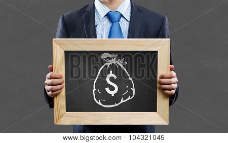 Unrecognizable businessman holding blackboard with drawn dollar concept