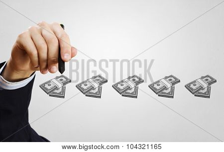 Close up of businessman drawing money making formula