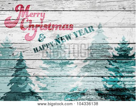 Grungy Christmas Greeting - Textured Christmas and New Year greeting card, with wood board effect and faded pine trees, whitewash, red and green