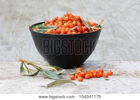 Sea Buckthorn In A Bowl On A Plank