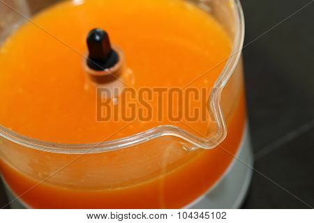 Fresh Orange Juice In Juicer Machine With Hand