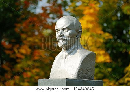Lenin Bust Monument With Autunm Leaves On The Background