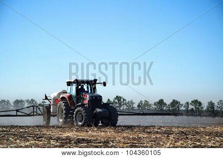 The Tractor Works In A Field