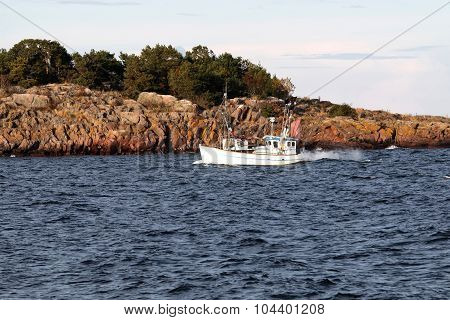 Small Fishingboat In Front Of An Island