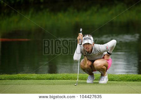 KUALA LUMPUR, MALAYSIA - OCTOBER 10, 2015: USA's Jessica Korda lines her putt at the green of the 18th hole of the KL Golf & Country Club during the 2015 Sime Darby LPGA Malaysia golf tournament.