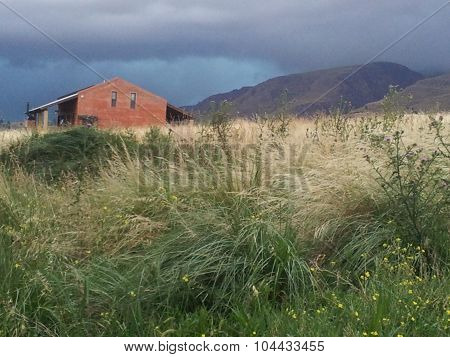 House in the field under the storm