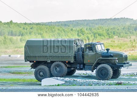 URAL-4320 curtain sided truck comes around on high obstacle