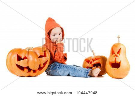 Baby And Halloveen Pumpkins With A Grimace On White Background