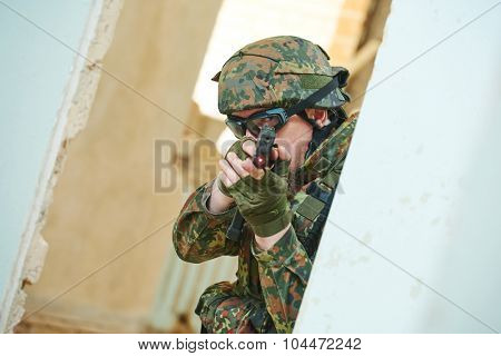 military. soldier with pistol in nato germany uniform indoors