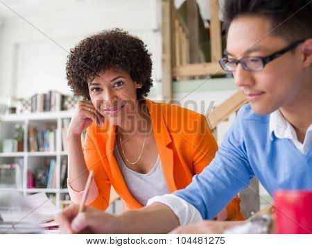 Two desingers working on a project together in office