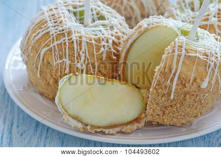 Caramel apple covered with white chocolate