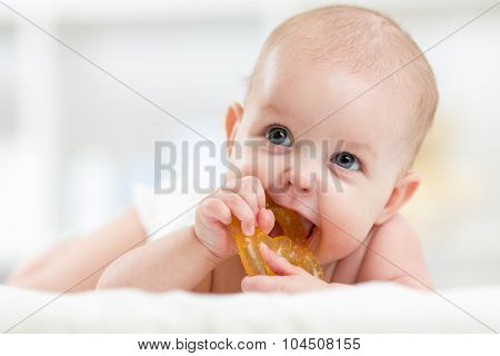 baby child lying on belly weared diaper with teether