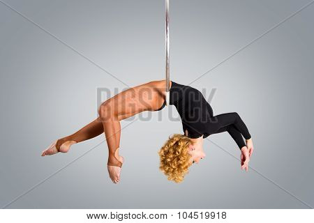 Plastic Beautiful Girl Gymnast On Acrobatic Circus Ring In Flesh-colored Suit. Aerial Ring.