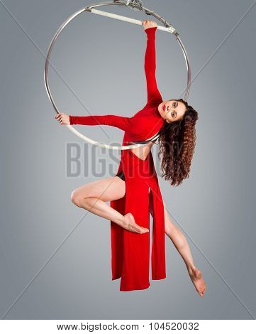 Plastic Beautiful Girl Gymnast On Acrobatic Circus Ring In Flesh-colored Suit. Aerial Ring.