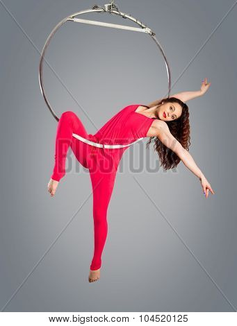 Plastic Beautiful Girl Gymnast On Acrobatic Circus Ring In Flesh-colored Suit. Aerial Ring.