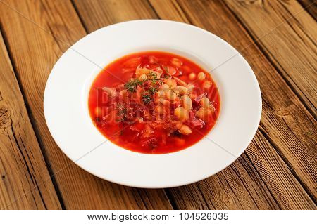 Portion Of Homemade Russian Red Beet Soup Borsch With Bean, Cabbage, Potato With Clean Spoon On Old