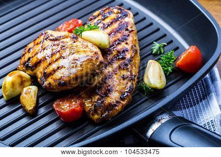 Grilled chicken breast in different variations with cherry tomatoes, green French beans, garlic