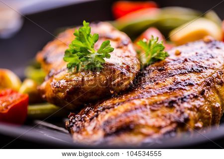 Grilled chicken breast in different variations with cherry tomatoes, green French beans, garlic